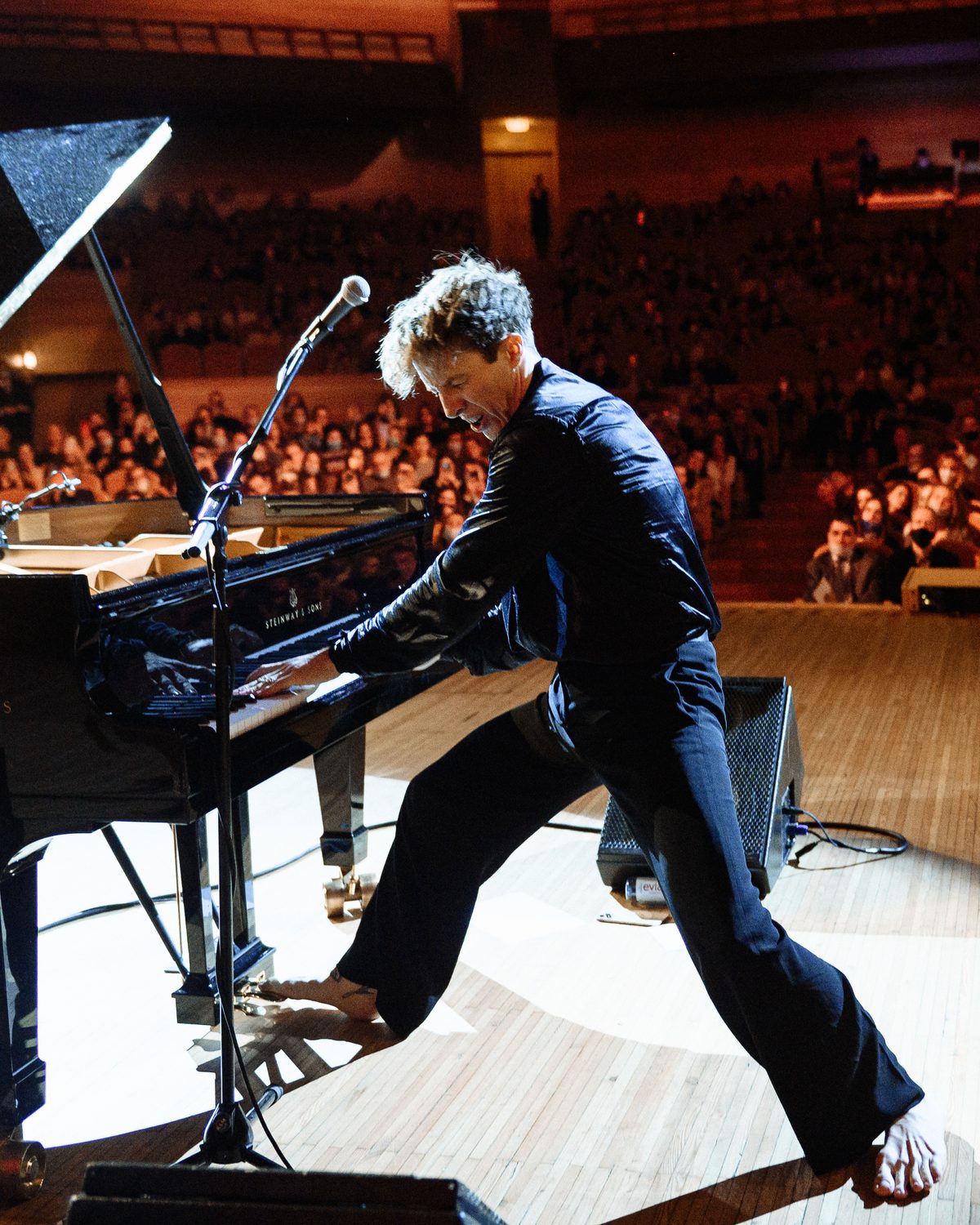 Stephen Ridley playing a grand piano mid-performance